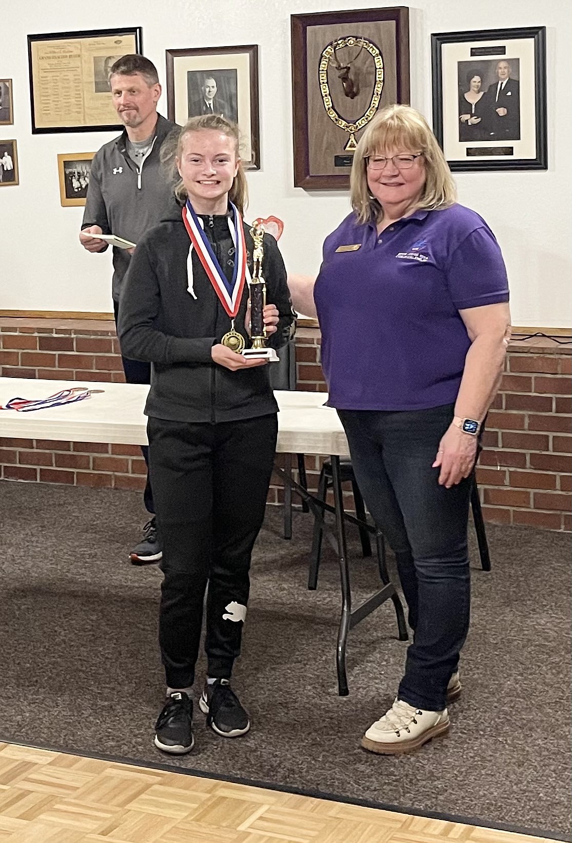 Courtesy photo
Malia Miller won the Waide Hamner (Top Gun) Award as the top overall scorer for the girls at the Coeur d'Alene Elks Hoop Shoot held Feb. 20 at The Courts at Real Life in Post Falls. Also pictured is Debbi Nadrchal, Elks Exalted Ruler, and Todd Stoddard, Hoop Shoot director.