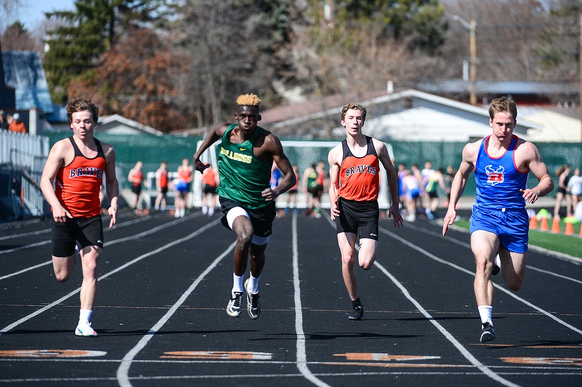 From left, Flathad's Nate Prieto, Whitefish's Marvin Kimera, Flathead's Sam Hopp and Bigfork's Joseph Farrier compete in the 100 meter dash during a track and field meet at Legends Stadium on Tuesday. (Casey Kreider/Daily Inter Lake)