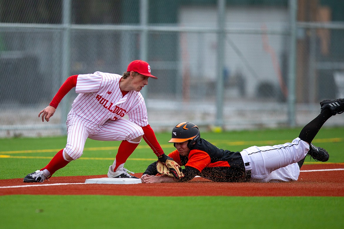 Sandpoint's Zeke Roop (left) tags Priest River's Coby Rogers before he reaches third base last Thursday.