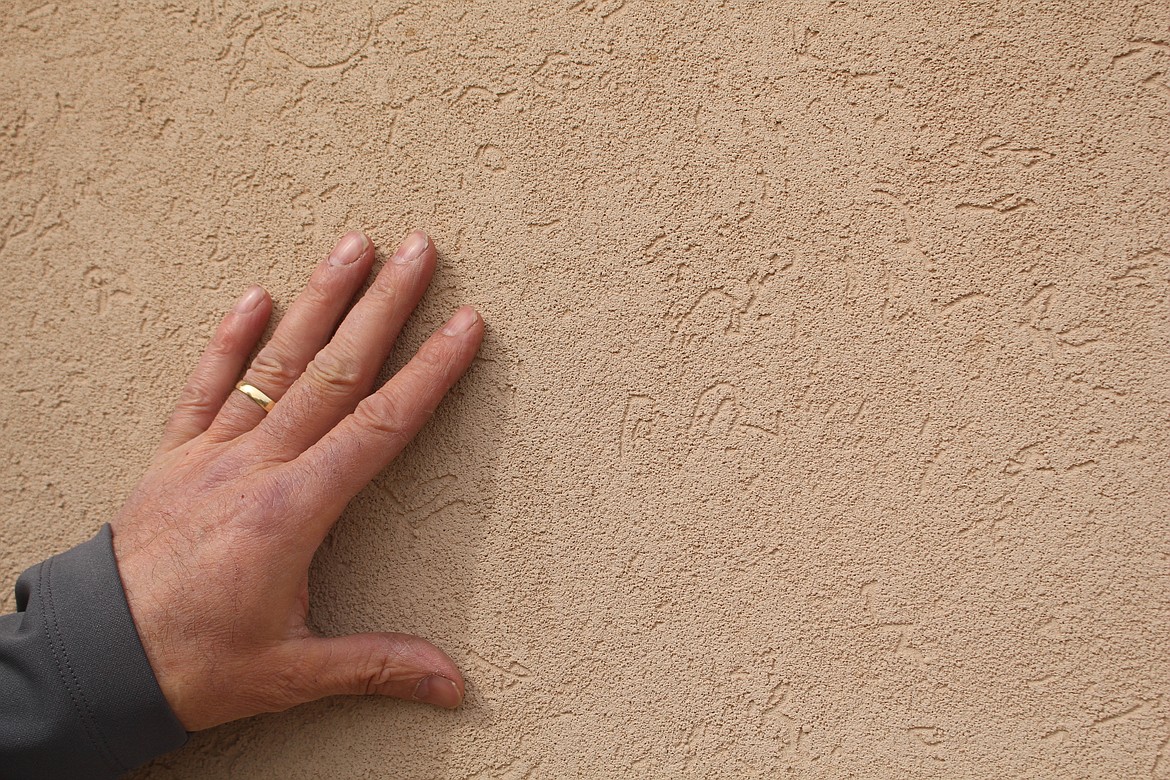 Moses Lake realtor Kevin Burgess showcases the stucco siding on a home outside Moses Lake on Wildgoose Road that's been a popular trend with home buyers recently.