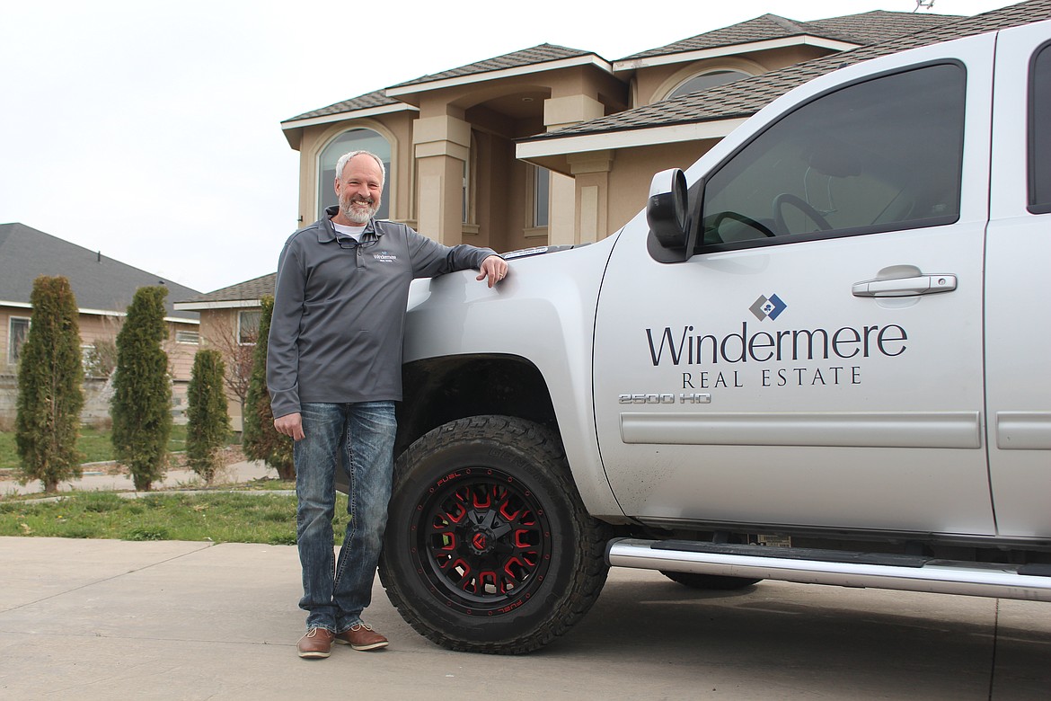 Kevin Burgess, managing broker for Windermere K2 Real Estate in Moses Lake, stands in front of a home on the market outside Moses Lake on Wednesday morning.