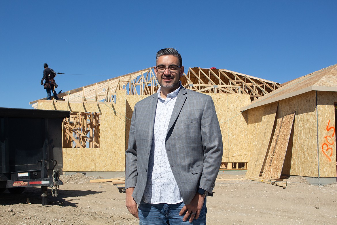 Othello realtor Jessie "Weno" Dominguez stands in front of a home currently being built in Othello on Tuesday afternoon.