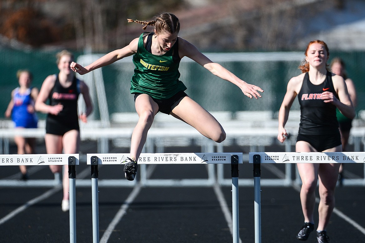 Whitefish's Hailey Ells clears the last jump in the 300 meter hurdles during a track and field meet with Bigfork and Flathead high schools at Legends Stadium on Tuesday. (Casey Kreider/Daily Inter Lake)