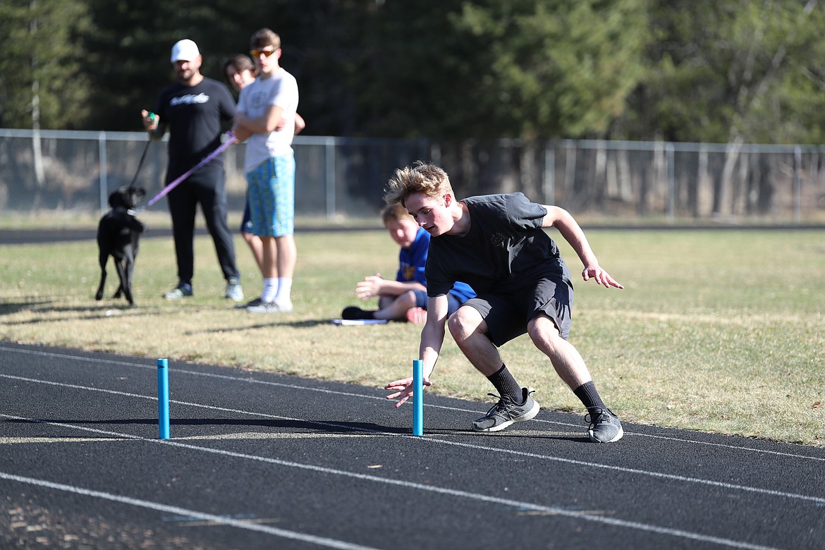 Wyatt Mintken gets down low to grab a baton during a drill last Friday at CFHS.