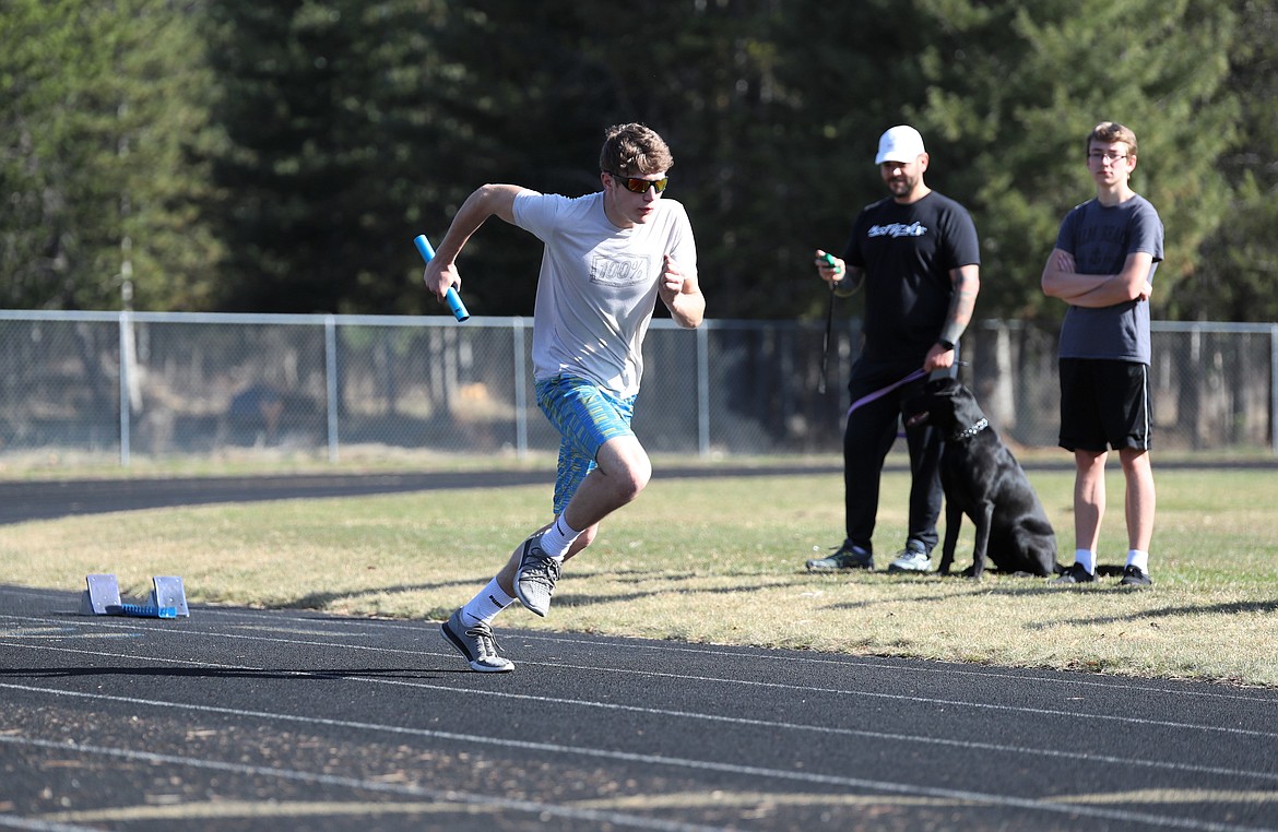 Nathan Shelton sprints with the baton during a drill last Friday at CFHS.