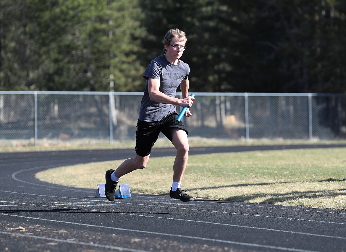 Ryan Matteson runs with a baton during a drill last Friday.
