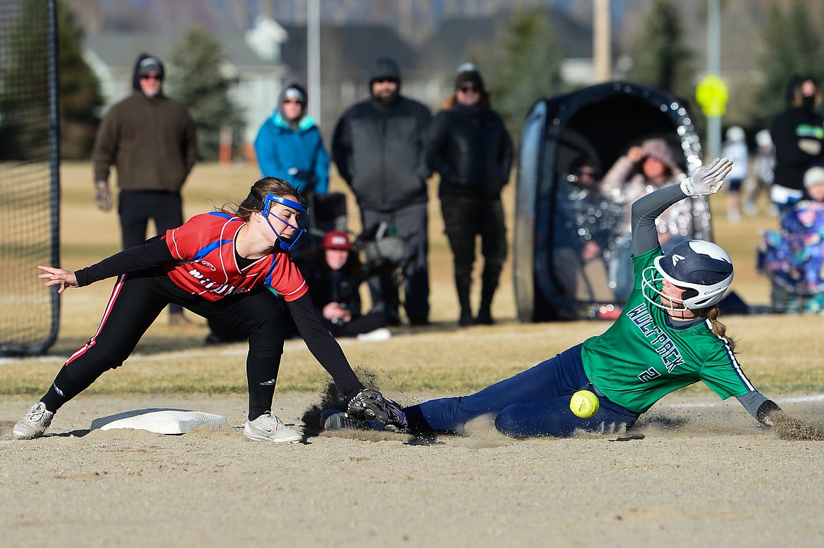 Glacier's Halle Schroeder (2) steals third base as the throw gets away from Columbia Falls third baseman Aletheia Fisher (2) at Glacier High School on Thursday. (Casey Kreider/Daily Inter Lake)