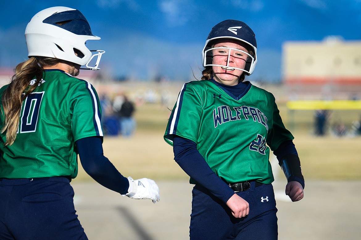 Glacier's Kenadie Goudette (20) celebrates with teammate Sammie Labrum (10) after Goudette's solo home run in the botttom of the third inning against Columbia Falls at Glacier High School on Thursday. (Casey Kreider/Daily Inter Lake)