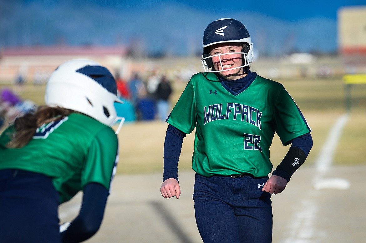 Glacier's Kenadie Goudette (20) celebrates with teammate Sammie Labrum (10) after Goudette's solo home run in the botttom of the third inning against Columbia Falls at Glacier High School on Thursday. (Casey Kreider/Daily Inter Lake)