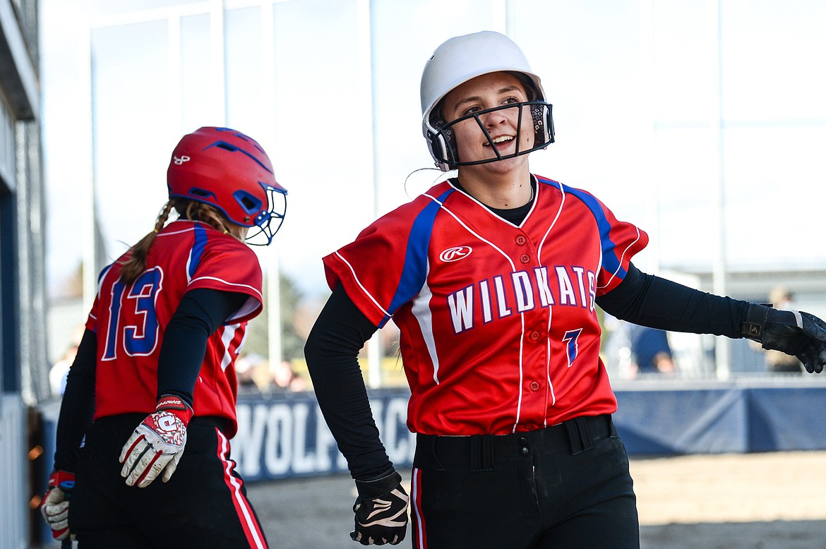 Columbia Falls' Alyssa Blankenship (7) gets congratulated by teammate Sydney Mann (13) after Blankenship scored a run against Glacier in the top of the third at Glacier High School on Thursday. (Casey Kreider/Daily Inter Lake)