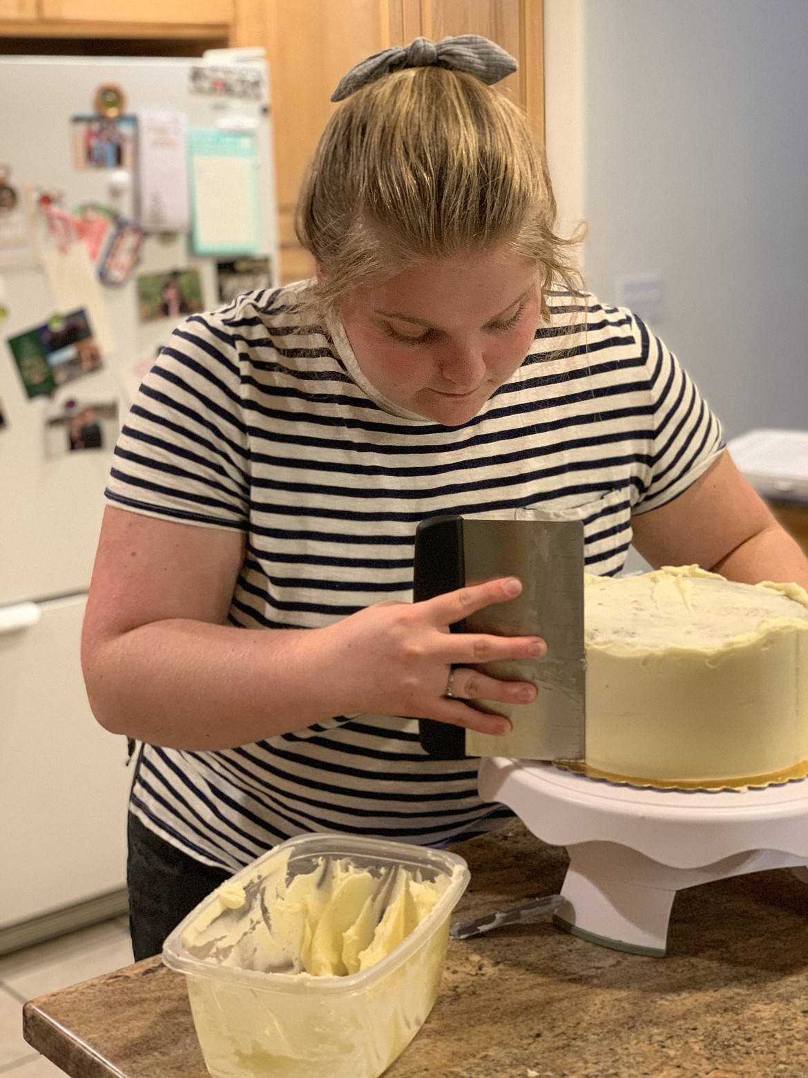 Paige Tolley frosts a custom cake. With time on her hands last summer, Tolley started her own custom cake business