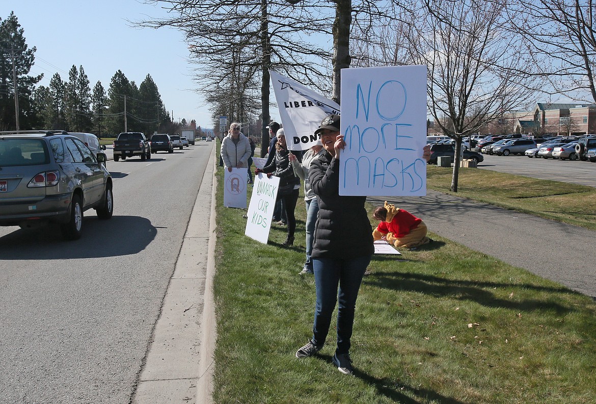 Coeur d'Alene mom of five Shilo Vogel holds a "No more masks" sign Friday morning outside of Lake City High School in protest of the Coeur d'Alene School District's mask requirement. Fewer than 50 students at schools across the district participated in the protest. Some were sent home or decided to spend the day in designated rooms where they were supervised and kept apart from other kids.