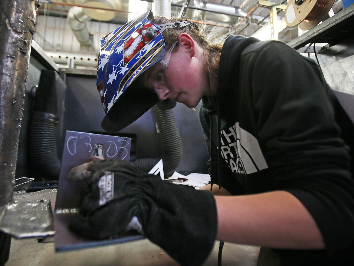 Braden Prior, a Lake City High School senior, chips slag off a weld Friday morning during a welding competition at KTEC in Rathdrum.