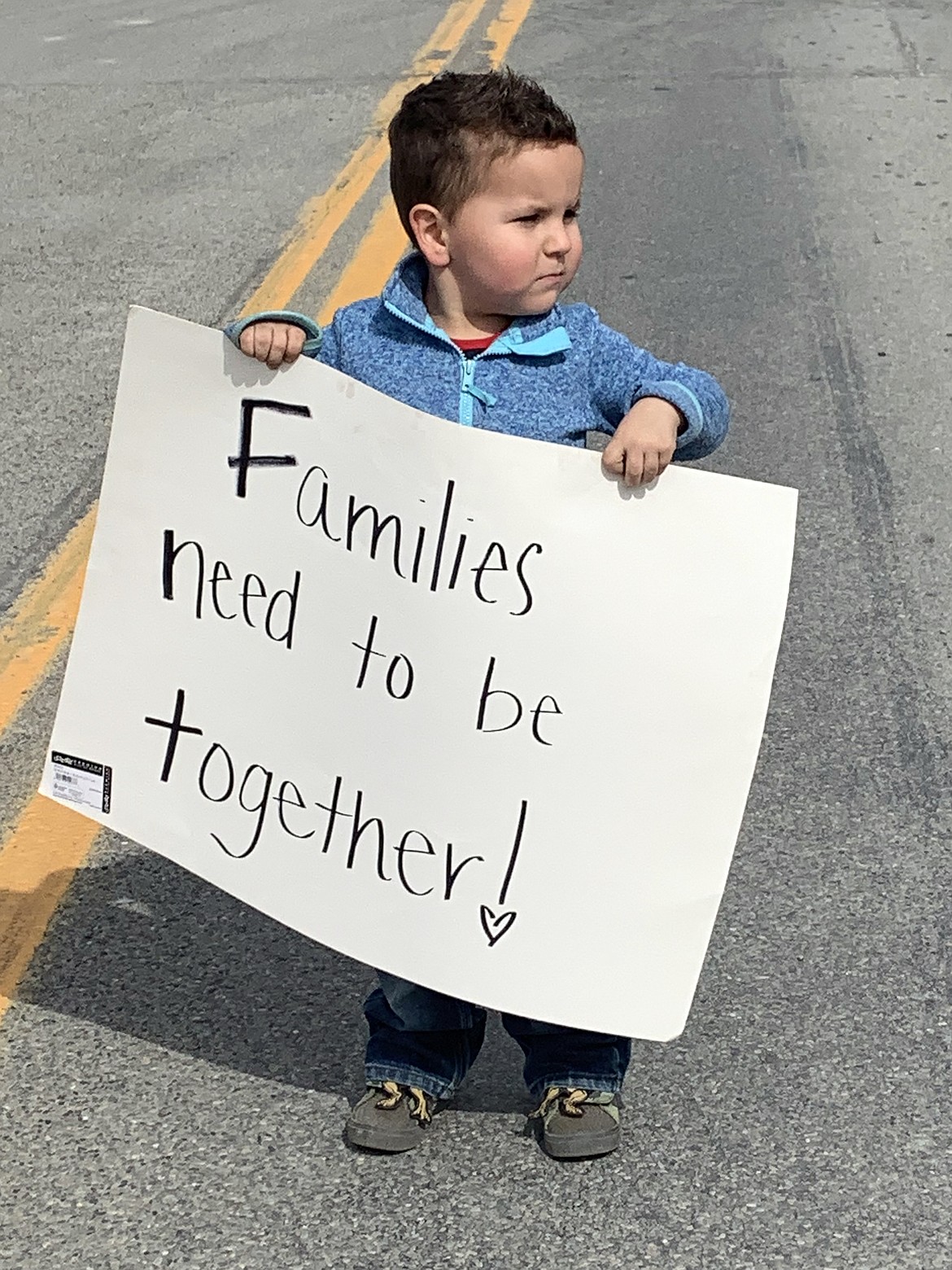 Four-year-old Colt Lynch of Eureka joins the peaceful demonstration at the Port of Roosville Saturday. Lynch's father, Charlie, lives in Canada. (Brandy Carvey photo)