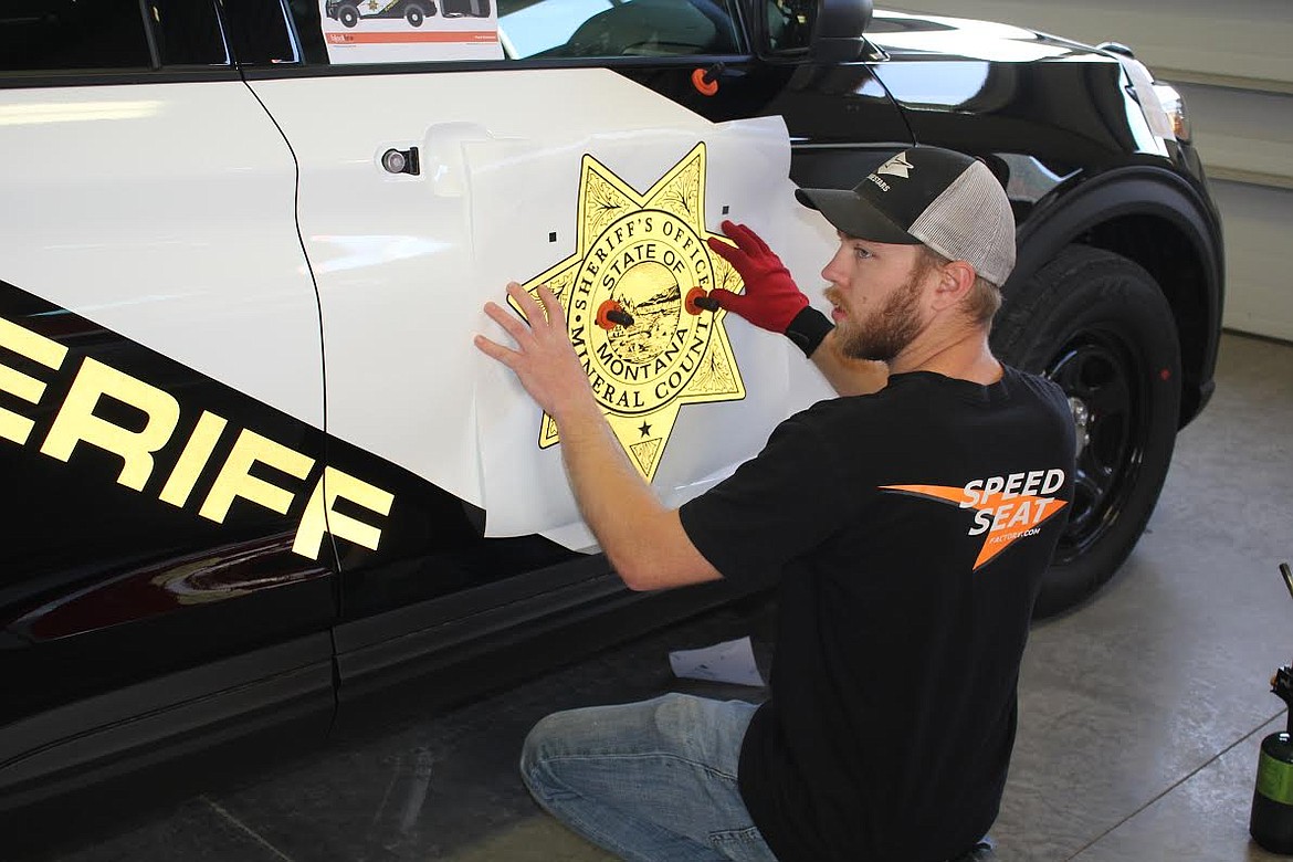 Blackfire Creative out of Farmington, Minnesota, sent three technicians, Nick Mueller, Mash Kirchoff and Derrick Borka, to install the reflective 3-mil vinyl 3 that they created for the 7-2021 Ford Interceptors the Mineral County Sheriff’s Office  took delivery on Tuesday, April 6. The Superior Volunteer Fire Department rearranged one of their bays for the day and a half installation process. Blackfire has five employees including the owner/operator and has designed and installed vinyl on many law enforcement vehicles but this was the furthest they have traveled. Golden Valley Police Department in Minnesota posted videos on Facebook that Sheriff Mike Toth saw which initiated the relationship. Blackfire Creative covered all expenses for Mueller, Kirchoff and Borka. Kirchoff installed the sheriff’s star. (Monte Turner/Mineral Independent)