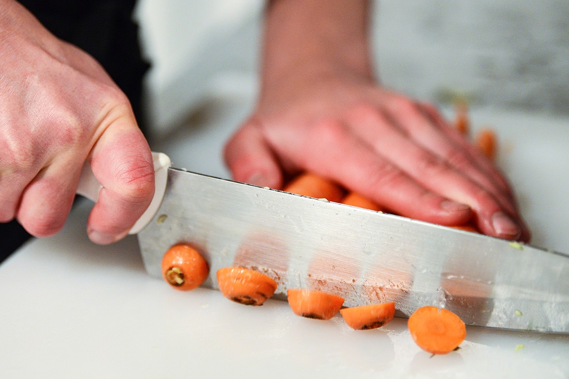 Vanessa Walsten chops carrots for her Spicy Carrots blend of Farmented on Friday, April 9. (Casey Kreider/Daily Inter Lake)