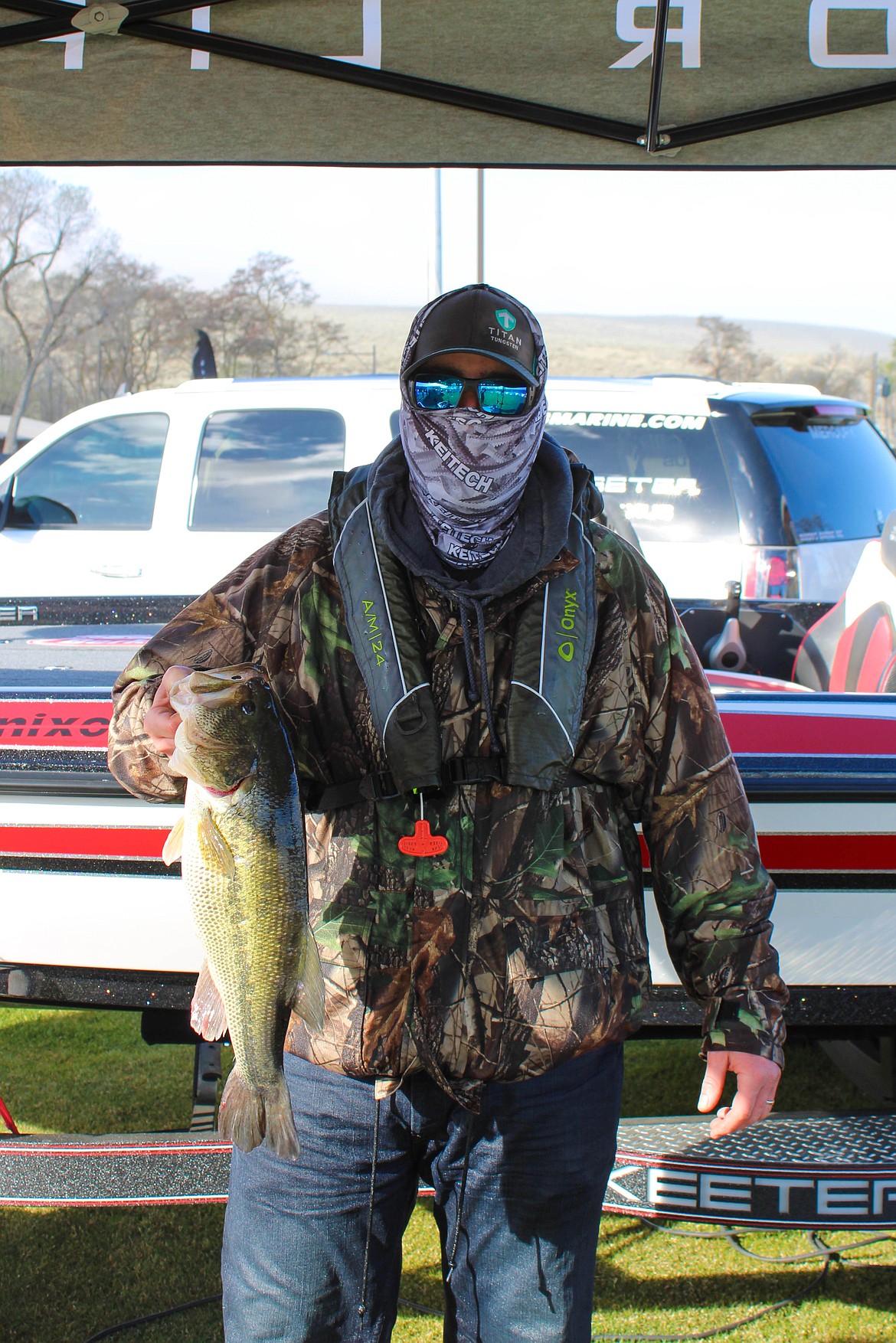 Randy Simmons holds his 5.9-pound largemouth bass, winner of the 9 o'clock hour and one of the day's biggest.
