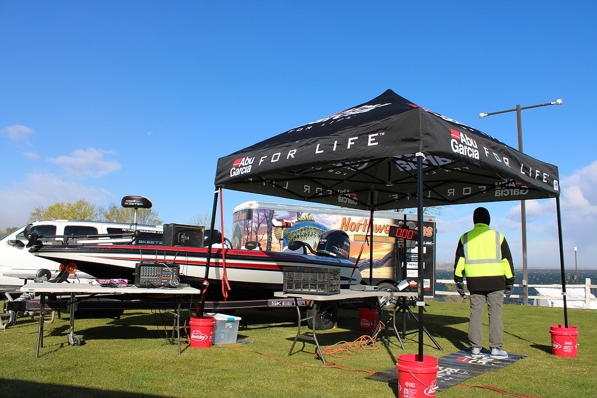 Northwest Bass announcer Willie Nelson takes to the microphone next to the grand prize, a Skeeter boat, for Saturday's bass tournament.