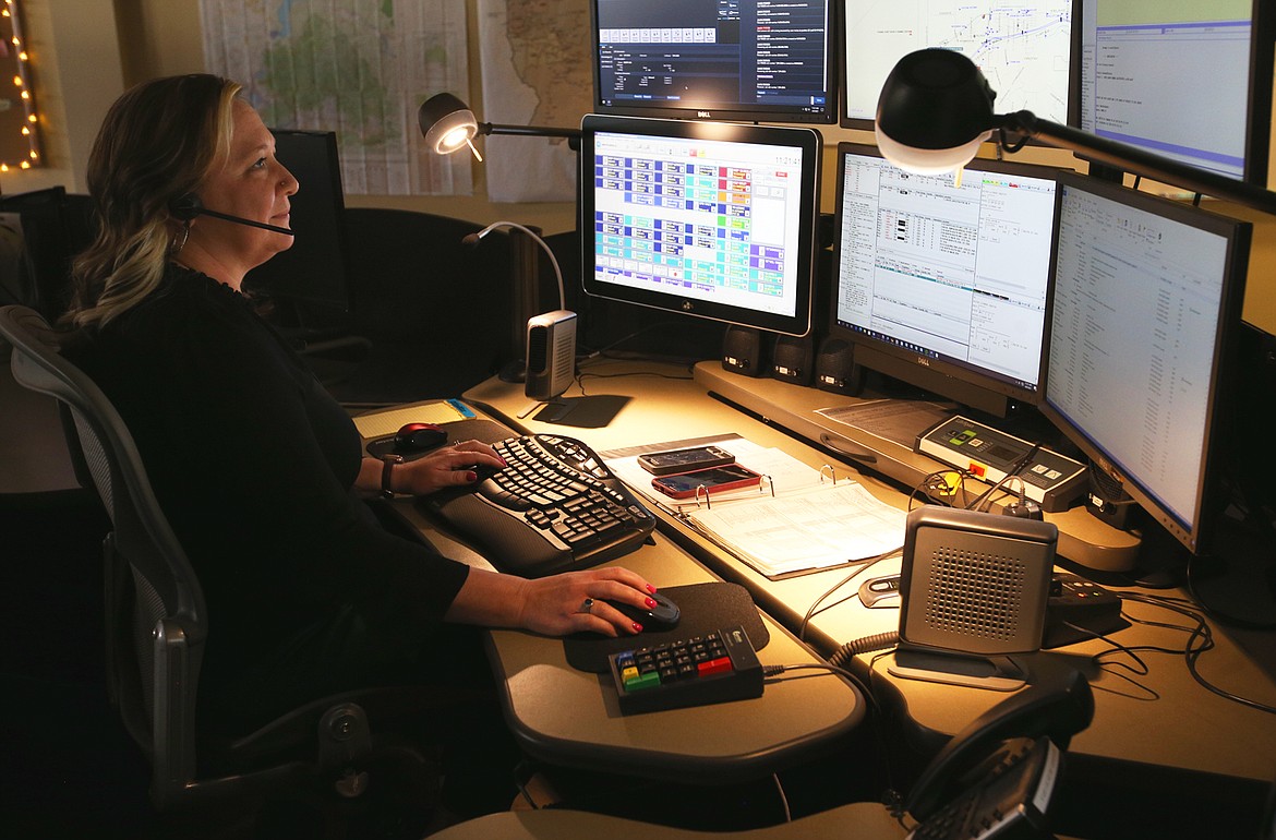 Jennifer Sullivan monitors screens and takes calls at the Idaho State Police Regional Communication Center in Coeur d'Alene on Friday.