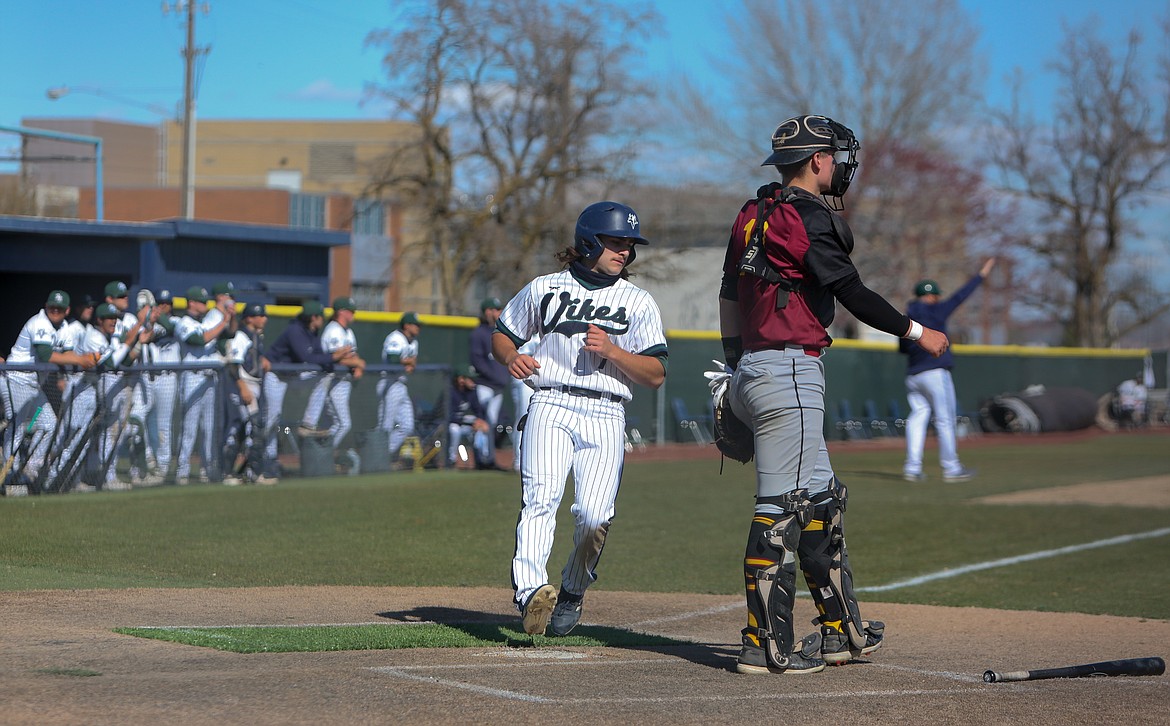 Teegan Zillyett comes across the plate to score for Big Bend Community College in the first matchup of the day with Yakima Valley College on Sunday.