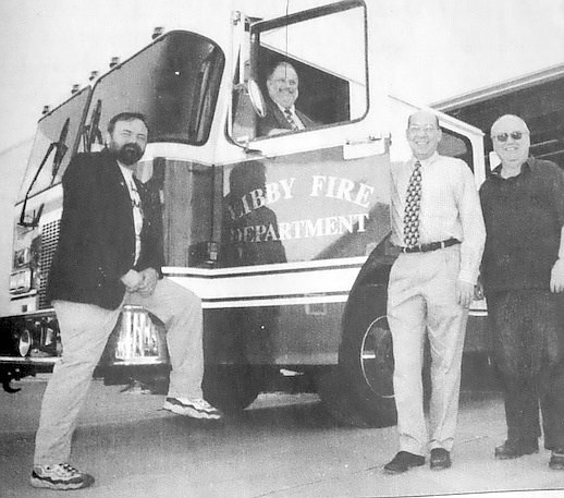 Tom Wood sits in a new fire truck along with then Mayor Tony Berget and Libby City councilors Dan Stephens and Eddy Baker. (Courtesy of Tom Wood)
