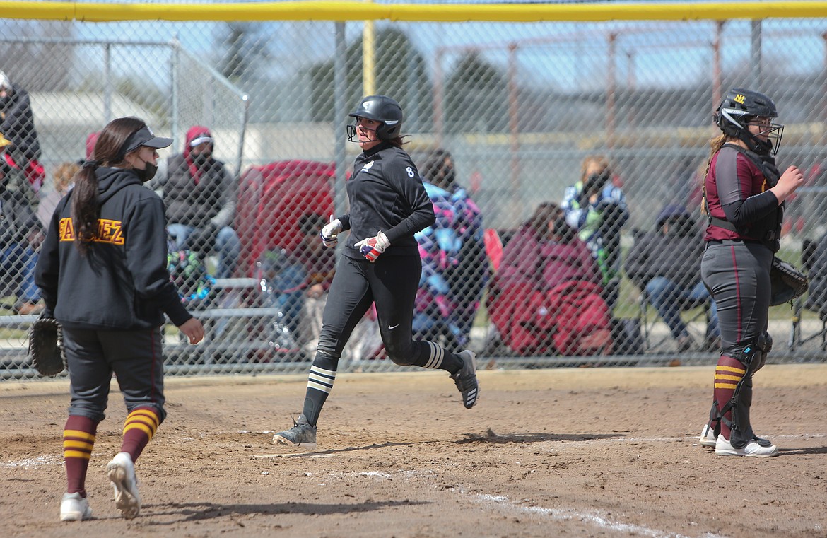 Royal High School's Chenoa Louie comes across home plate to score in the scrimmage against Moses Lake High School at the softball jamboree in Moses Lake on Saturday afternoon.