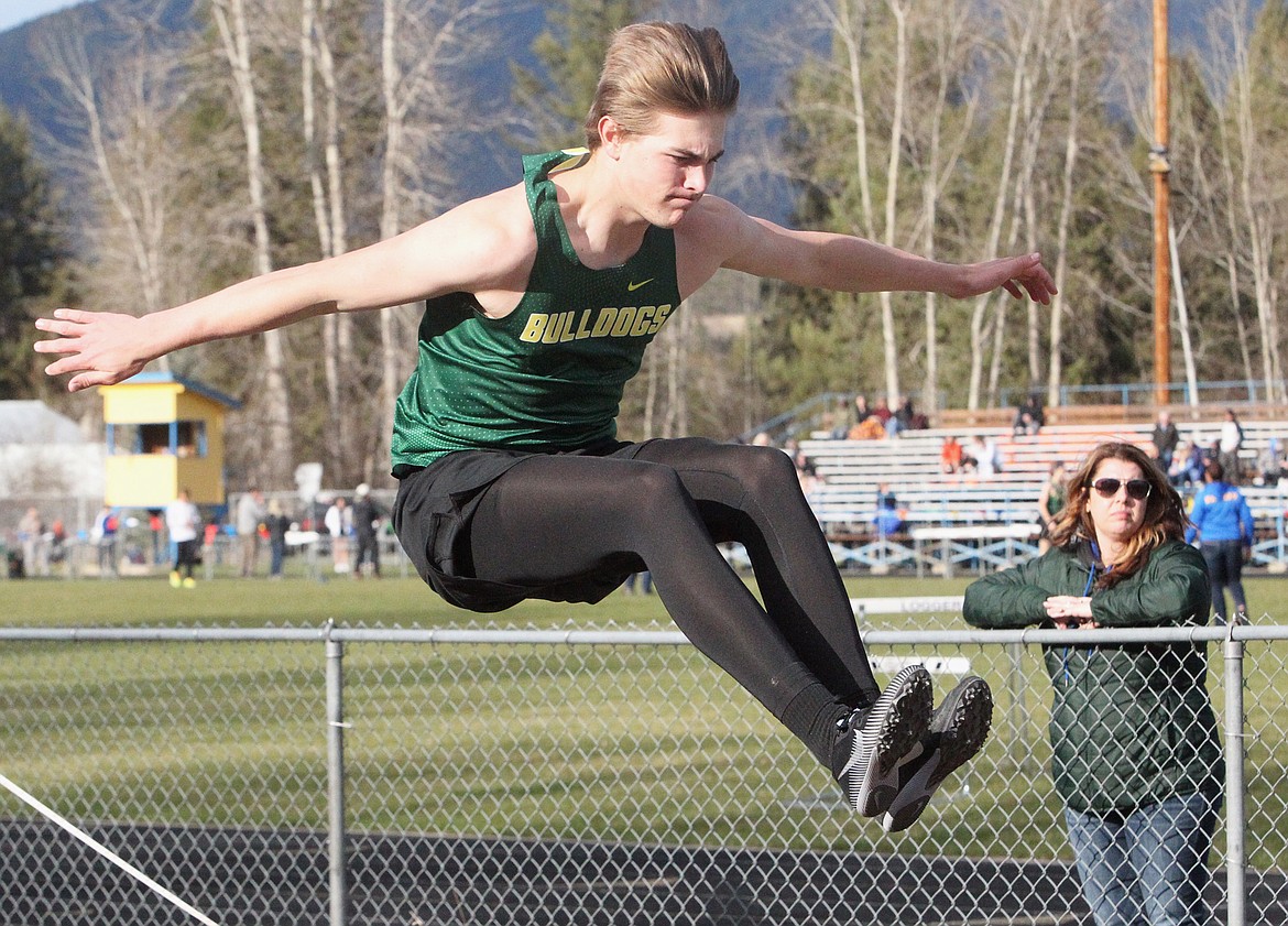 Whitefish's Trey Hunt competes in the long jump at the track and field meet in Libby on Friday. (Will Langhorne/The Western News)