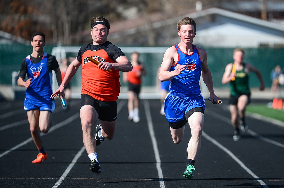 Flathead's Alec Thomas and Bigfork's Noah Kinslow approach the finish line in the 400 meter relay during a track meet with Flathead, Bigfork and Whitefish high schools at Legends Stadium on Tuesday. (Casey Kreider/Daily Inter Lake)