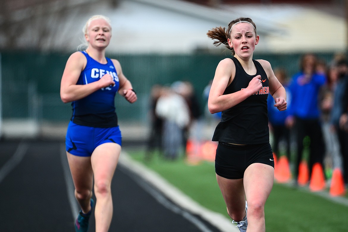 Flathead's Lilli Rumsey Eash and Columbia Falls' Lara Erickson approach the finish line in the girls' 1600 meter run during a track and field meet at Legends Stadium on Tuesday. (Casey Kreider/Daily Inter Lake)
