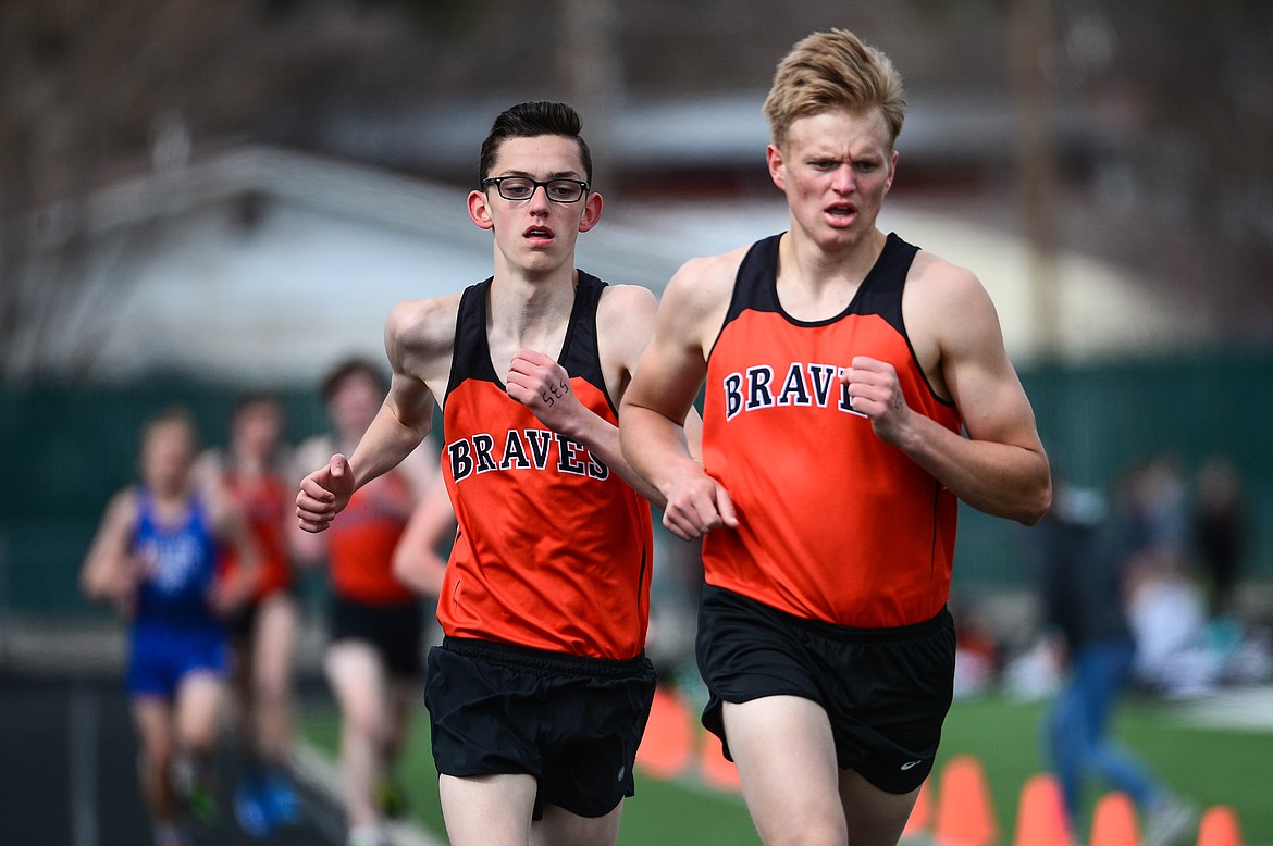 Flathead's Kesler Hughes, right, and Bauer Holman compete in the boys' 1600 meter run during a track and field meet at Legends Stadium on Tuesday. (Casey Kreider/Daily Inter Lake)