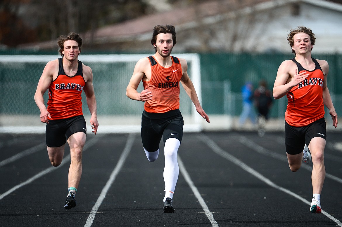 Eureka's Joshua Butts, center, competes in the boys' 200 meter dash during a track and field meet at Legends Stadium on Tuesday. (Casey Kreider/Daily Inter Lake)