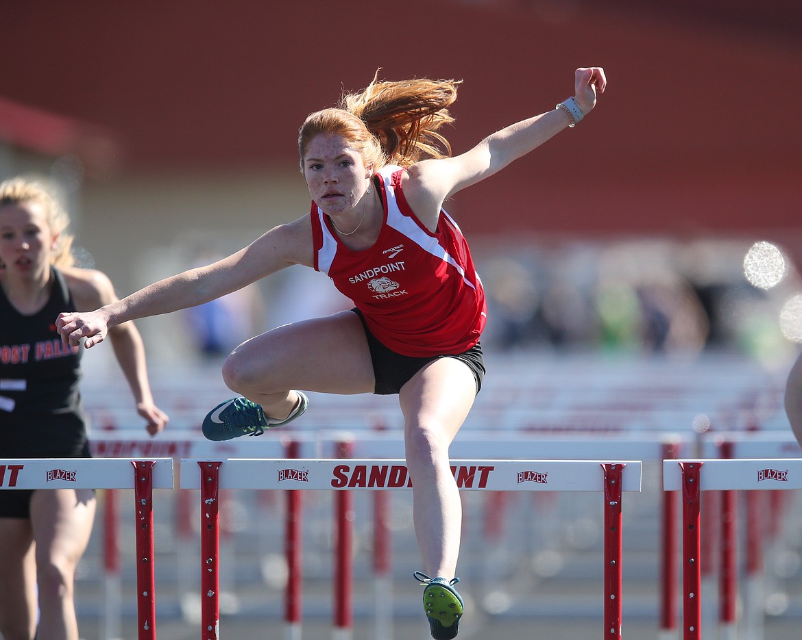 Taylor Petz competes in the 100 hurdles on Tuesday at Sandpoint High. She took second in the event and won the girls pole vault.