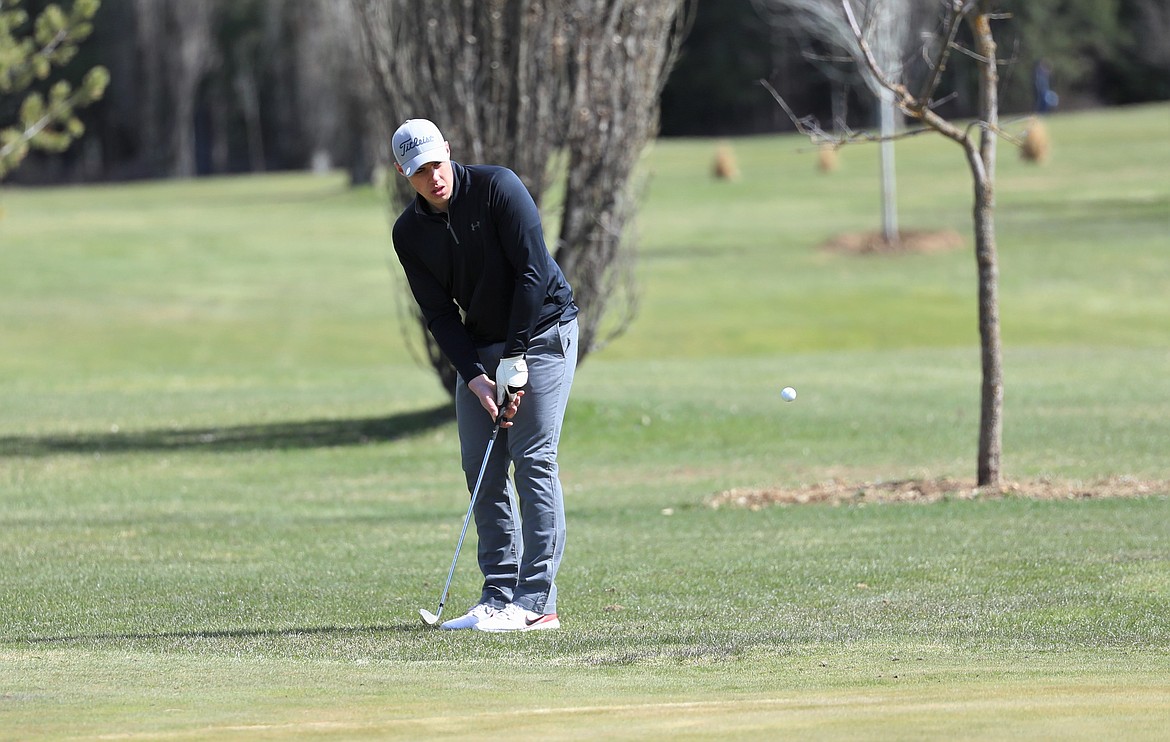 Jace Yount chips the ball onto the green during Monday's match.