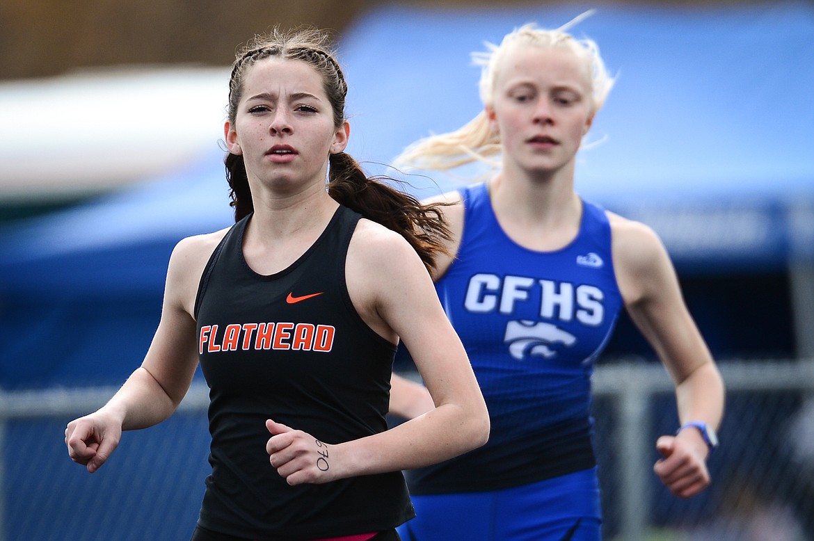 Flathead's Tori Noland-Gillespie leads Columbia Falls' Siri Erickson in the girls' 800 meter run during a track and field meet at Legends Stadium on Tuesday. (Casey Kreider/Daily Inter Lake)