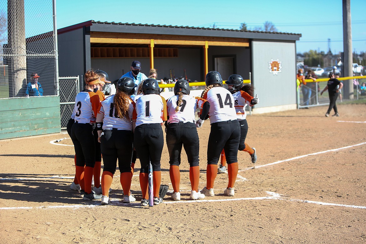 The Tigers wait to celebrate with Crystal Vela after she knocked a grand slam home run in the bottom of the first inning to help Ephrata jump out to an early lead on Wednesday.