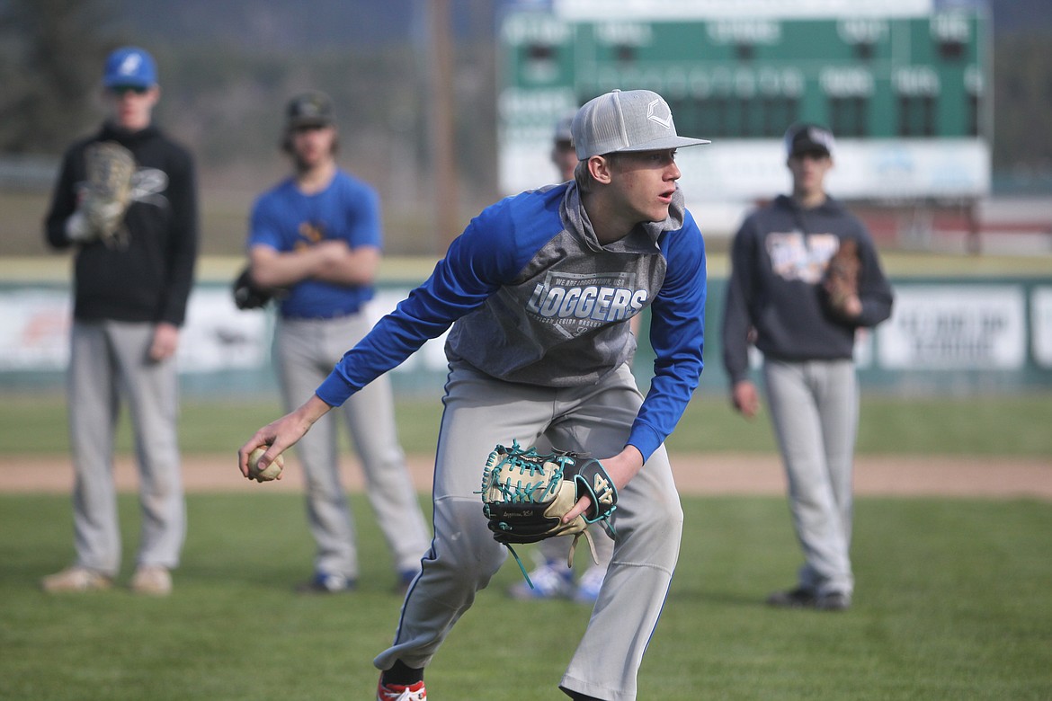 Cy Williams picks up a grounder during an April 13 practice. (Will Langhorne/The Western News)