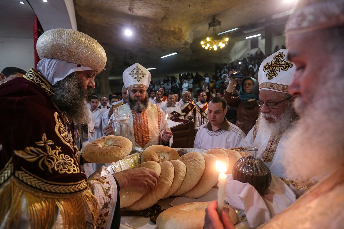 Coptic Christians attend Orthodox Christmas Eve Mass in the Cave Cathedral or St. Sama’ans Church overlooking Cairo (2015).