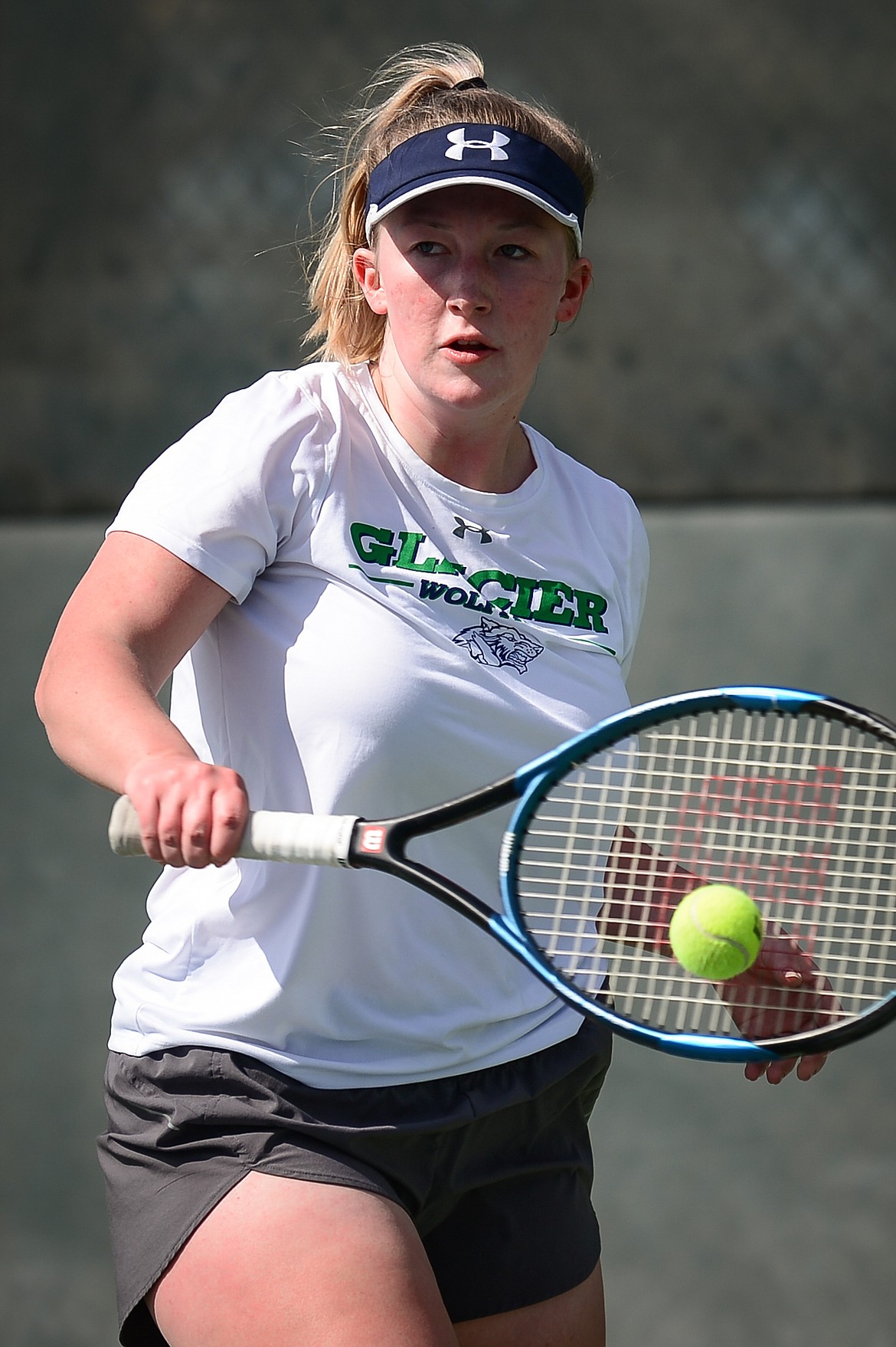 Glacier's Mariah Dickey hits a return in a match against Flathead's Emma Hawkins at Flathead Valley Community College on Thursday. (Casey Kreider/Daily Inter Lake)