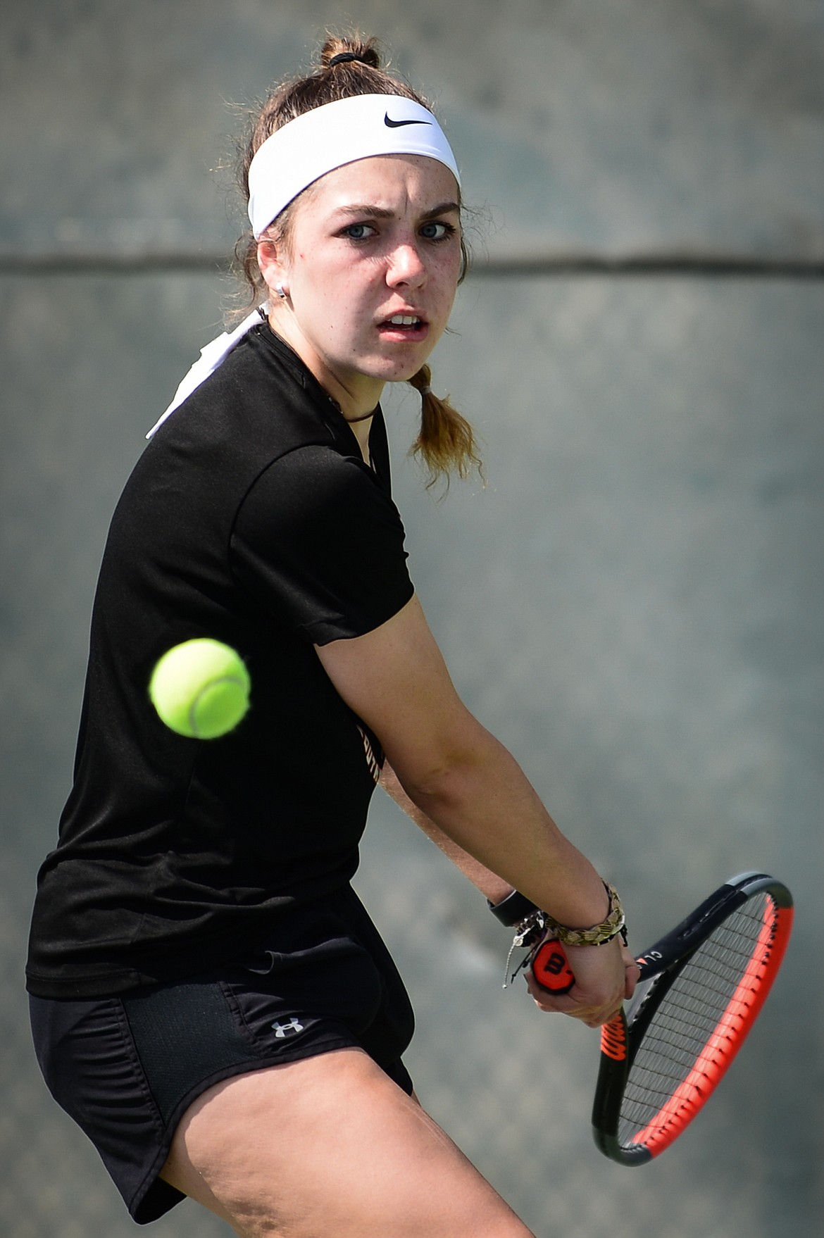 Flathead's Emma Hawkins hits a return in a match against Glacier's Mariah Dickey  at Flathead Valley Community College on Thursday. (Casey Kreider/Daily Inter Lake)