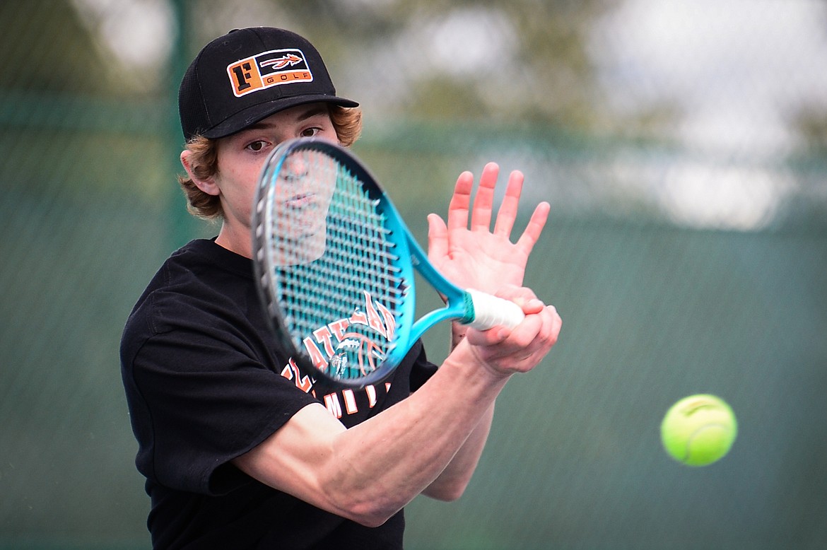 Flathead's Joston Cripe hits a return in a match against Glacier's Ethan Purdy at Flathead Valley Community College on Thursday. (Casey Kreider/Daily Inter Lake)