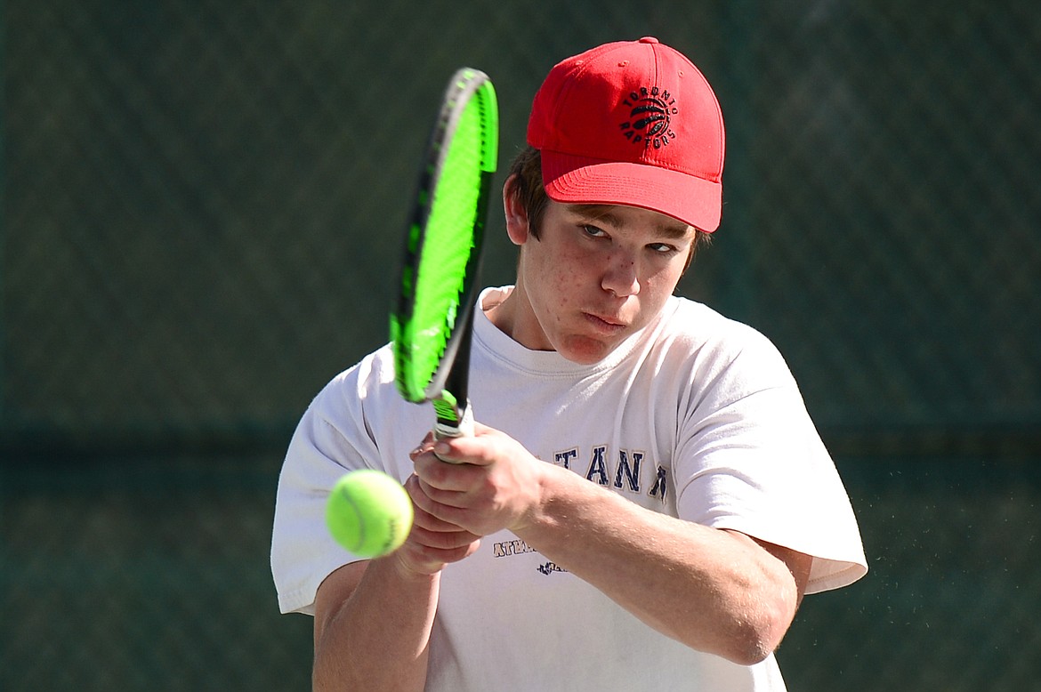 Flathead's Kutuk White hits a return in a doubles match with teammate Ethan Vandenbosch against Glacier's Alex Galloway and Harrison Sanders at Flathead Valley Community College on Thursday. (Casey Kreider/Daily Inter Lake)