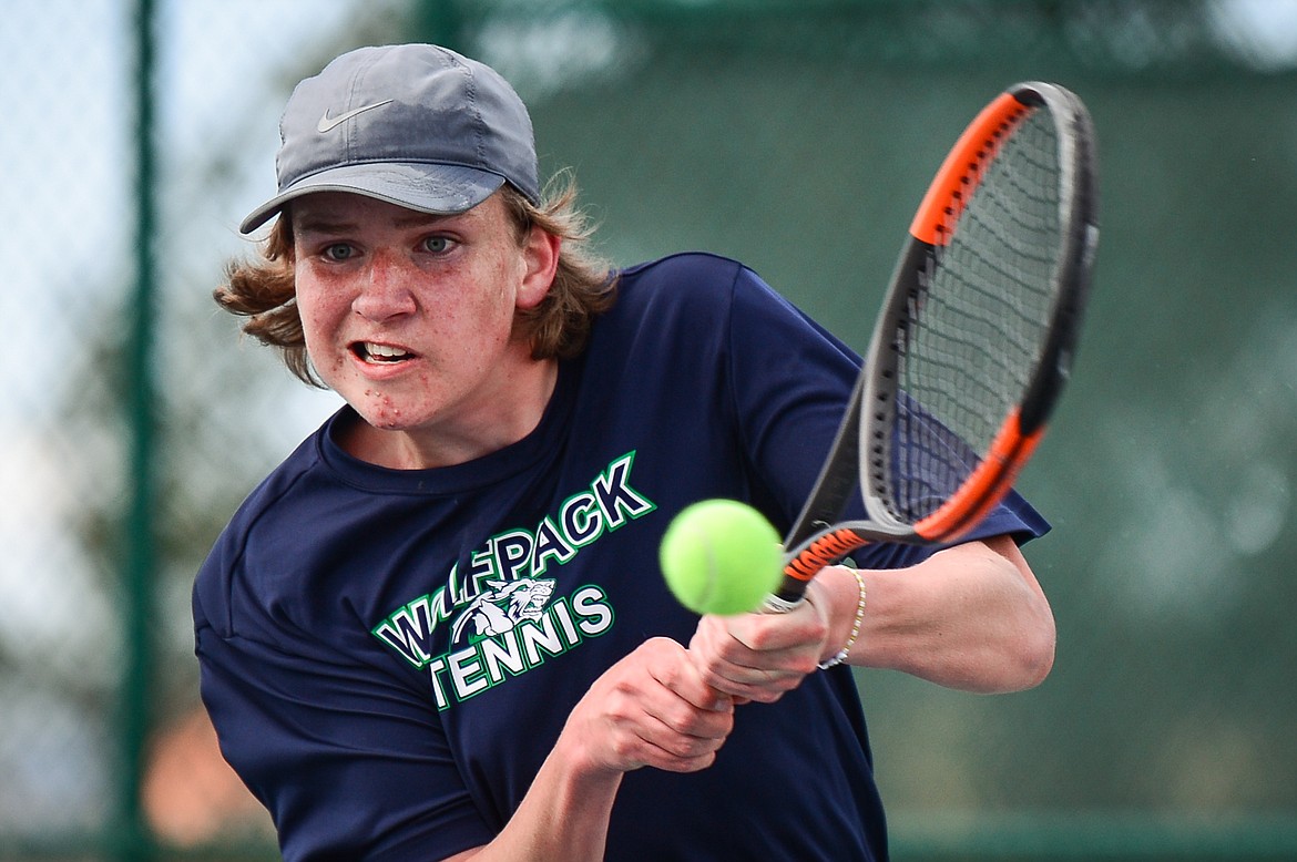 Glacier's Rory Smith hits a return in a match against Flathead's Nolan White at Flathead Valley Community College on Thursday. (Casey Kreider/Daily Inter Lake)