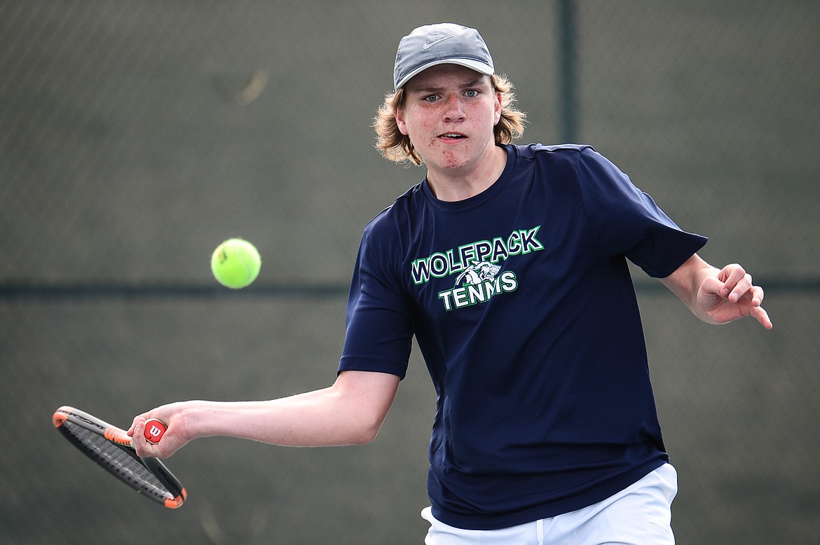 Glacier's Rory Smith hits a return in a match against Flathead's Nolan White at Flathead Valley Community College on Thursday. (Casey Kreider/Daily Inter Lake)