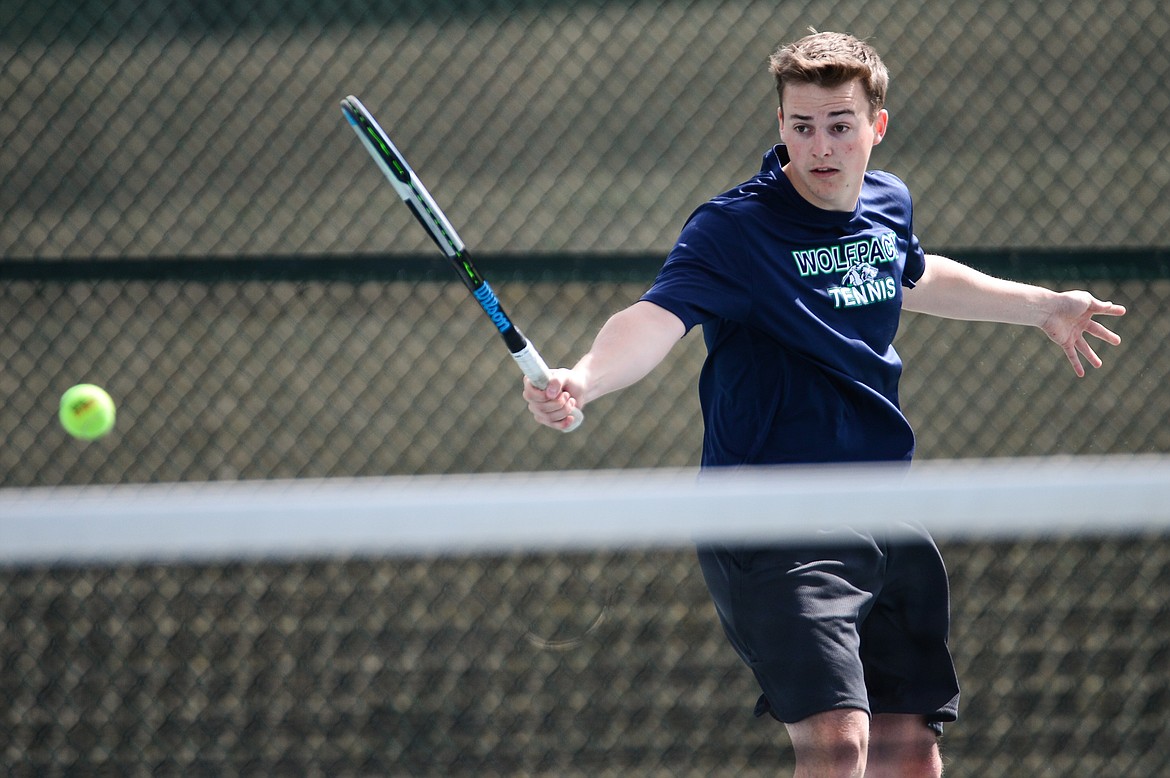 Glacier's Ethan Purdy hits a return in a match against Flathead's Joston Cripe at Flathead Valley Community College on Thursday. (Casey Kreider/Daily Inter Lake)