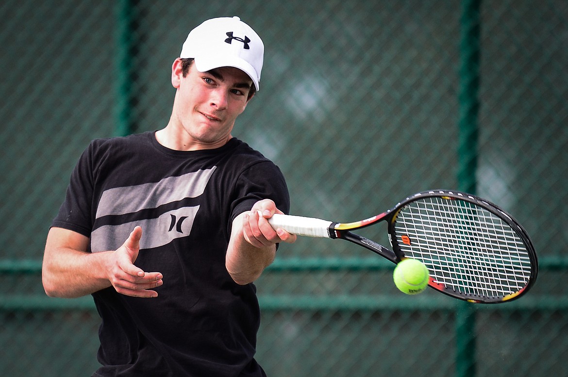 Flathead's Nolan White hits a return in a match against Glacier's Rory Smith at Flathead Valley Community College on Thursday. (Casey Kreider/Daily Inter Lake)