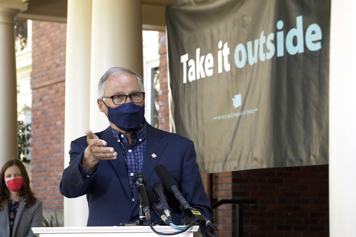 Washington Gov. Jay Inslee speaks to reporters outside of the governor’s mansion on the Capitol campus Thursday, April 15, 2021, in Olympia, Wash. Inslee held the outdoor news conference to urge people to get vaccinated and to socialize and conduct business outside as much as possible to help slow further the spread of COVID-19.