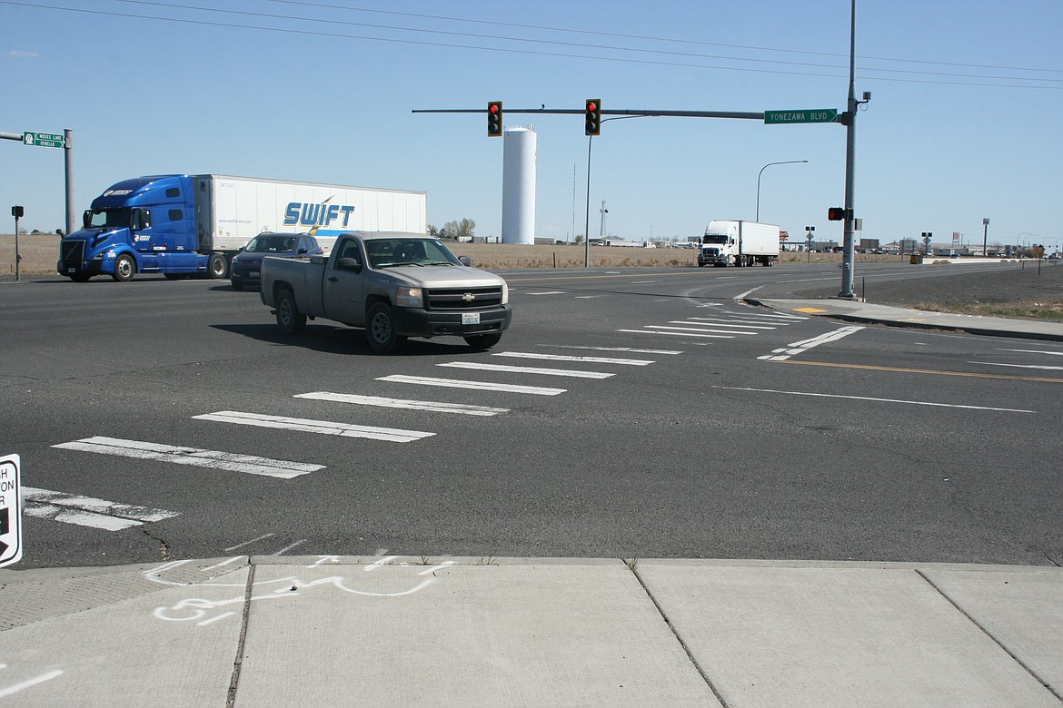 Vehicles traverse the intersection at Yonezawa Boulevard and Pioneer Way. Construction at the intersection has been delayed.