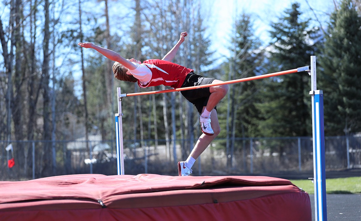 Stone Lee clears the bar in the high jump.