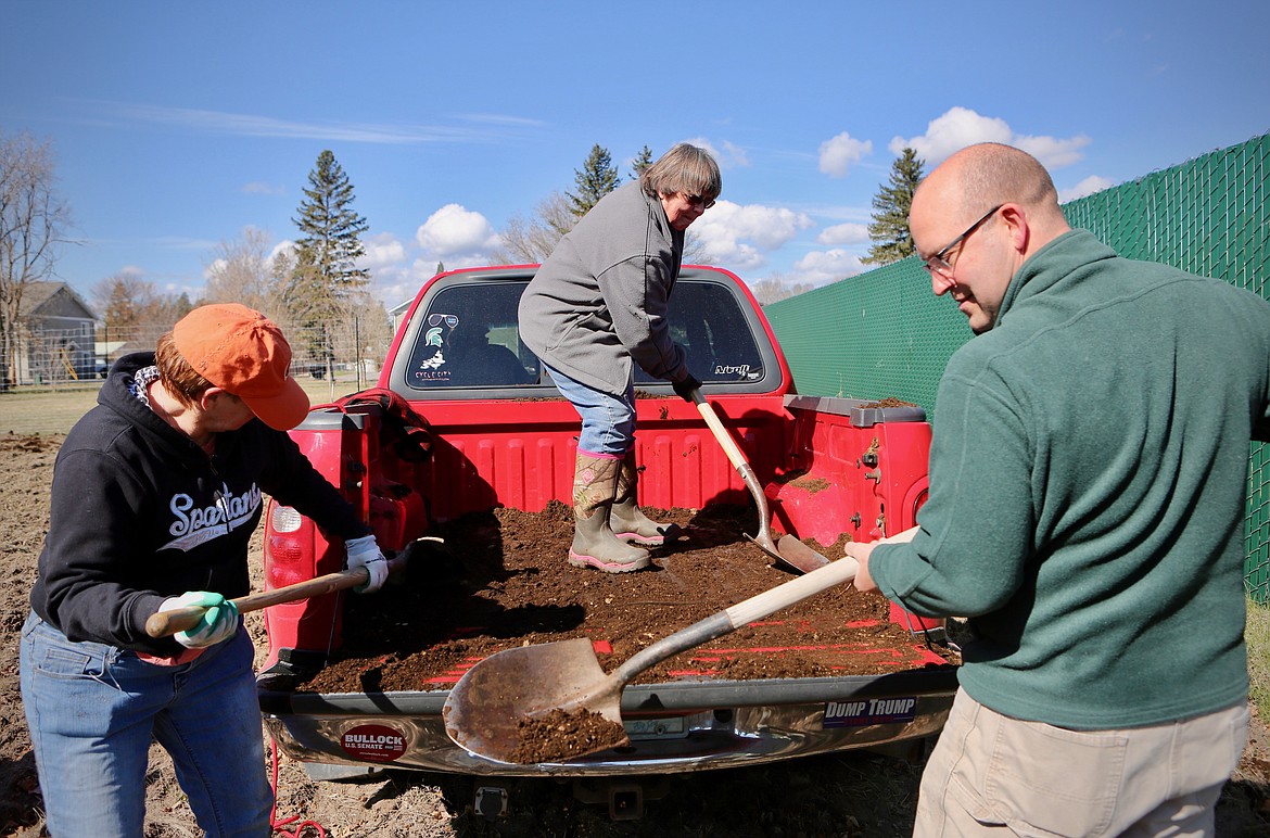 Katie Reiss, Yvonne Nelson and Pastor Craig Nissen spread manure on the soil at the Evergreen Community Garden on Monday, April 12.
Mackenzie Reiss/Daily Inter Lake