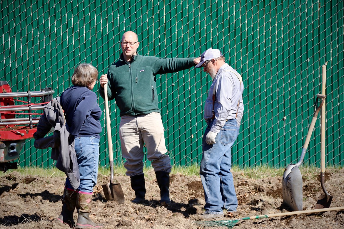 Yvonne Nelson, Pastor Craig Nissen and Lowell Nelson fertilize the soil at the Evergreen Community Garden on Monday, April 12.
Courtesy Dan Hafferman